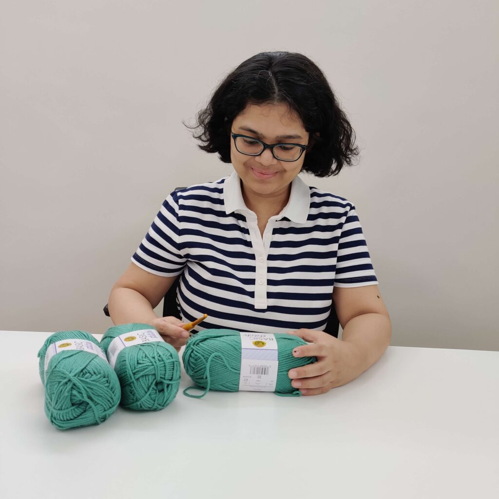 picture of me with my yarn ready to crochet at my desk